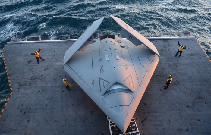 A fighter jet is launched from an aircraft carrier